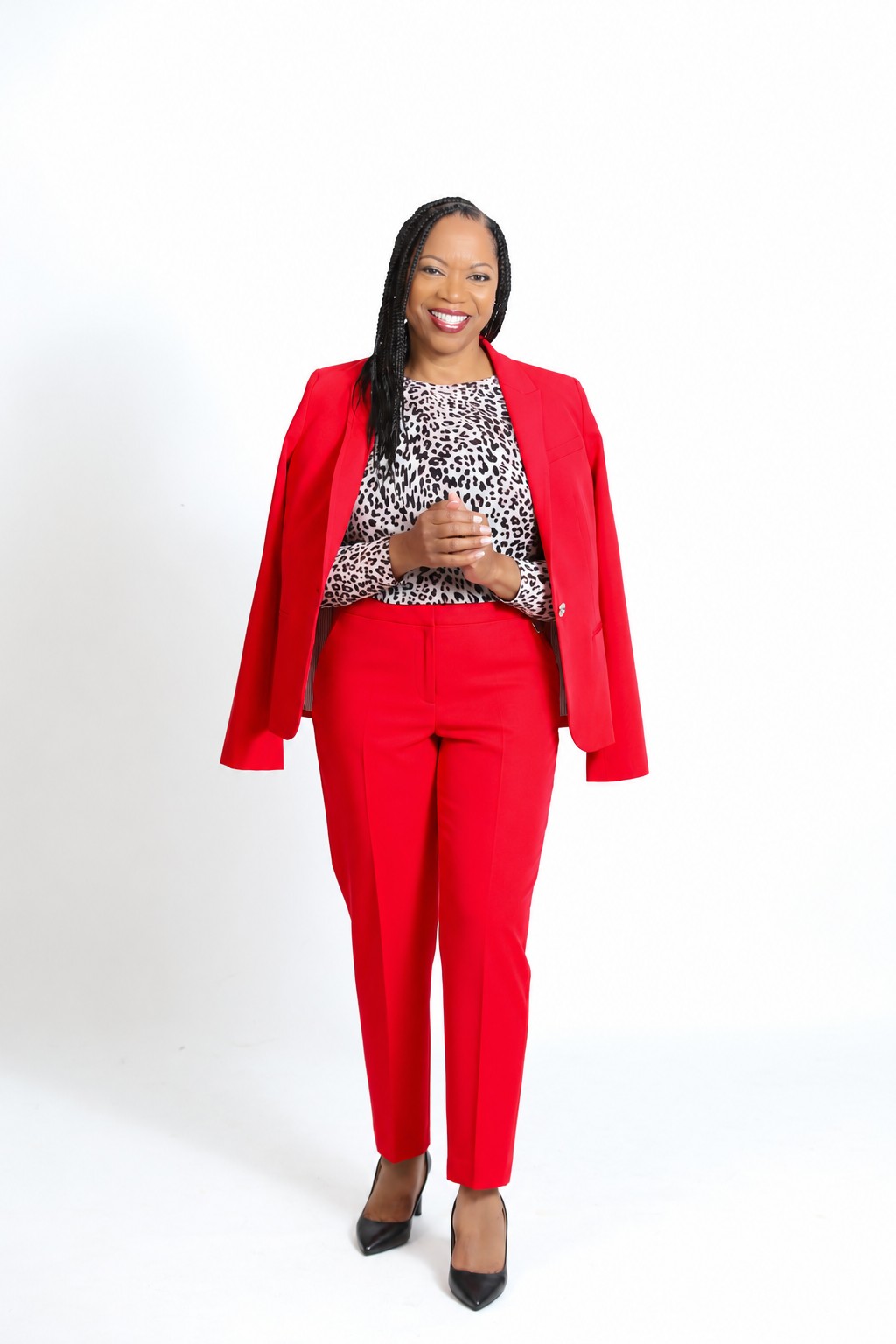 Dinah Rainey standing in a red suit.